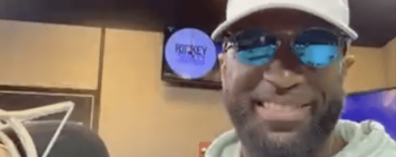 Man smiling in a radio studio.